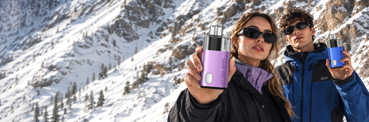 Hikers holding the ATING BAR Lekker X smart refillable pod kit with real-time LED battery screen in a snowy mountain setting.