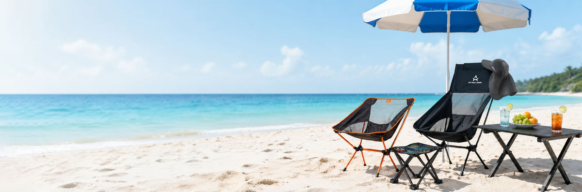 ATING BAR branded beach umbrella with ultra-portable folding moon chairs and camp table set up on a white sand beach.